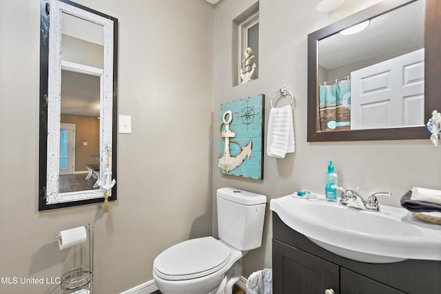 1160 Lucas Rd, Lucedale, MS 39452 - bathroom with toilet, vanity, and baseboards