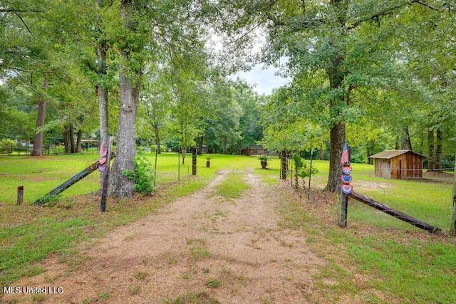 1160 Lucas Rd, Lucedale, MS 39452 - view of community featuring a yard, view of wooded area, an outbuilding, and driveway