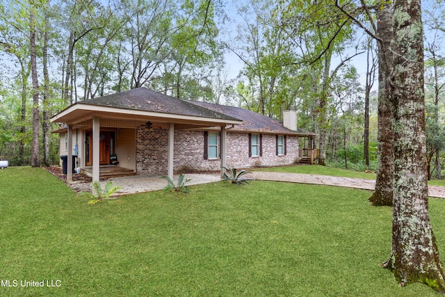 rear view of property with central AC, ceiling fan, and a yard