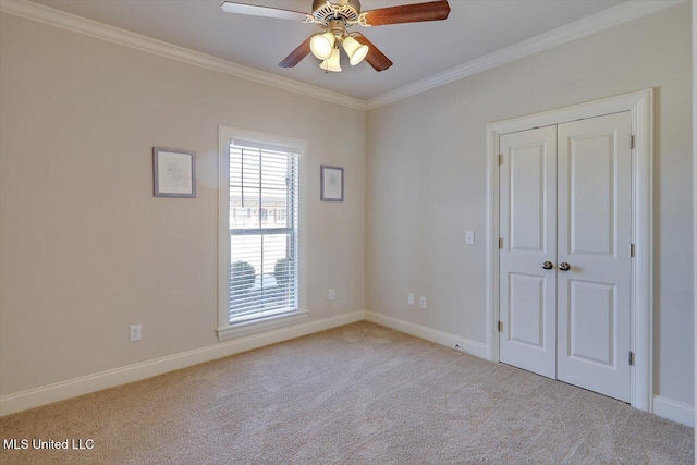 unfurnished room with baseboards, ornamental molding, and carpet flooring