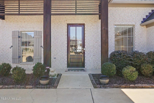 entrance to property featuring stucco siding