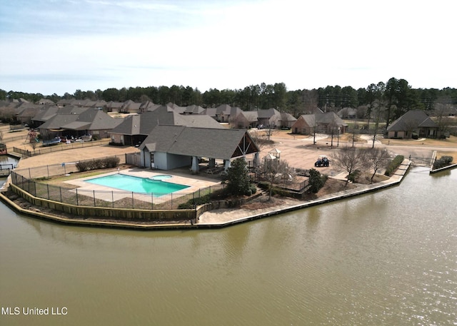 view of swimming pool with a residential view, a fenced backyard, a water view, and a patio