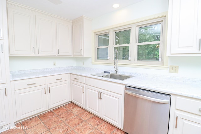 kitchen with stainless steel dishwasher, a sink, white cabinets, recessed lighting, and light tile patterned flooring