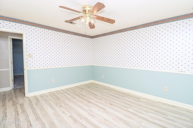 spare room with a ceiling fan, baseboards, and wood finished floors