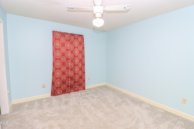 unfurnished room featuring carpet floors and baseboards