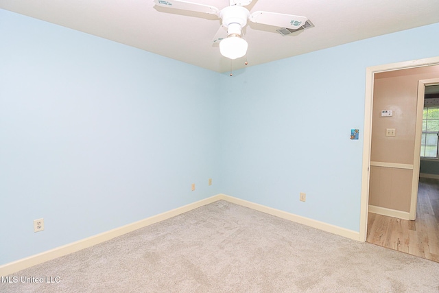unfurnished room featuring carpet, baseboards, and a ceiling fan
