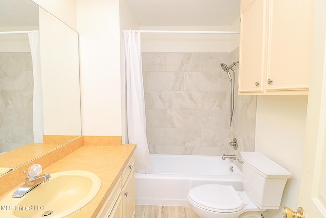 full bath featuring toilet, shower / bath combo with shower curtain, vanity, and wood finished floors