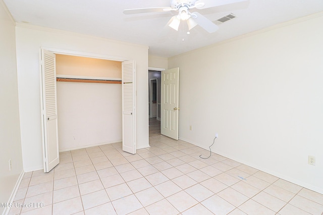 unfurnished bedroom with ornamental molding, a closet, and a ceiling fan