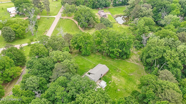 view of property location with a tree filled landscape