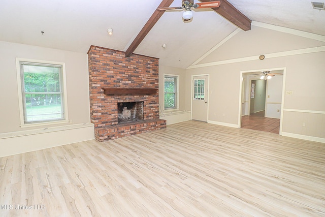 unfurnished living room with a ceiling fan, wood finished floors, and plenty of natural light