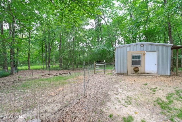 view of yard with fence, an outdoor structure, and a storage unit