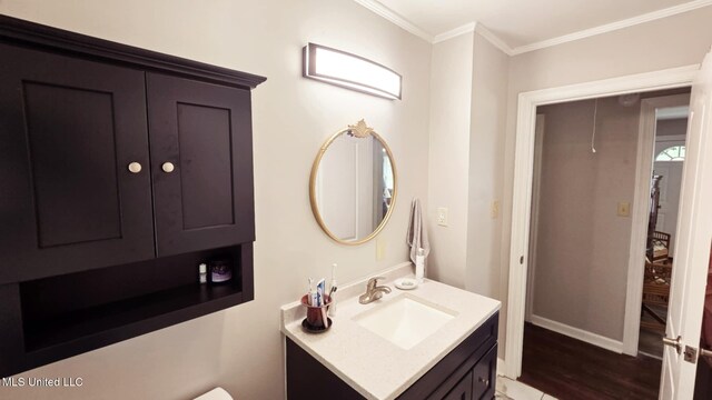 260 Roberts Ave, Holly Springs, MS 38635 - bathroom with crown molding, vanity, baseboards, and wood finished floors