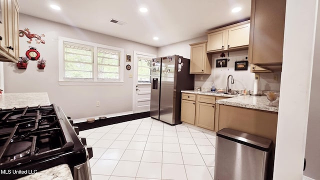 260 Roberts Ave, Holly Springs, MS 38635 - kitchen with light tile patterned flooring, appliances with stainless steel finishes, a sink, recessed lighting, and visible vents