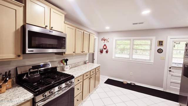 260 Roberts Ave, Holly Springs, MS 38635 - kitchen with visible vents, light tile patterned flooring, recessed lighting, cream cabinetry, and stainless steel appliances