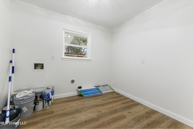 clothes washing area featuring laundry area, washer hookup, wood finished floors, and baseboards