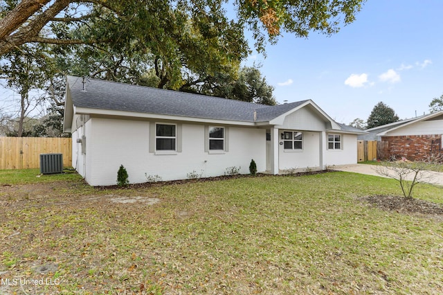 single story home featuring a shingled roof, fence, central air condition unit, a front yard, and brick siding