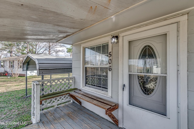 view of exterior entry featuring a lawn