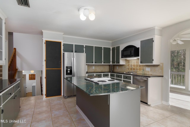 kitchen with visible vents, appliances with stainless steel finishes, decorative backsplash, and light tile patterned flooring