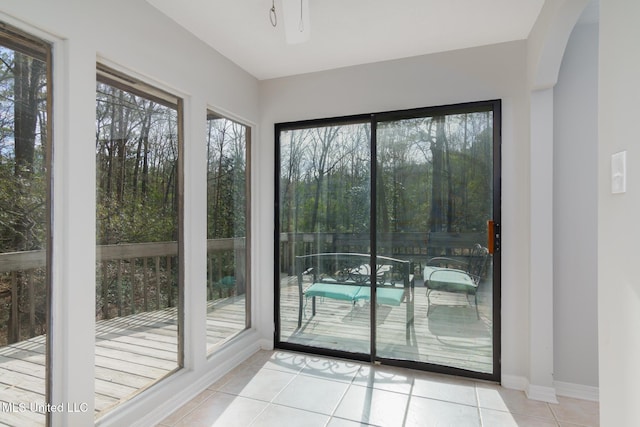 entryway featuring light tile patterned flooring, a wealth of natural light, and baseboards