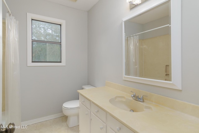 bathroom with a shower with shower curtain, toilet, vanity, tile patterned flooring, and baseboards