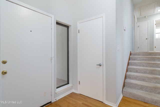 interior space with wood finished floors, attic access, and baseboards