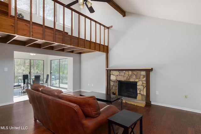 living room with a fireplace, wood finished floors, beam ceiling, and baseboards