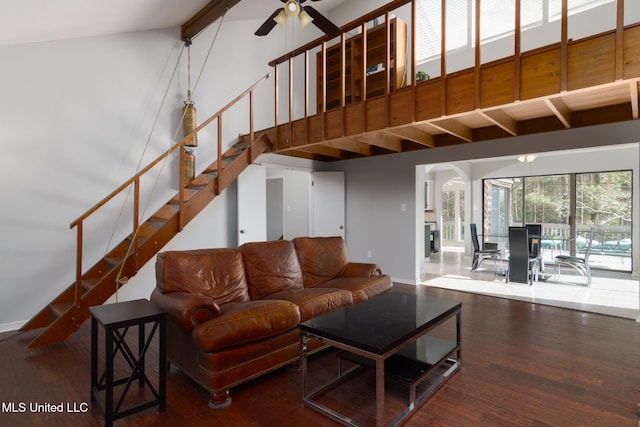 living area featuring ceiling fan, high vaulted ceiling, wood finished floors, stairs, and beamed ceiling