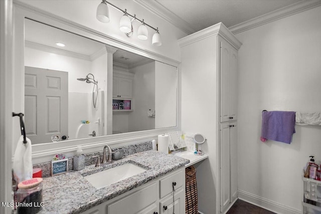 bathroom with vanity, a shower, and ornamental molding