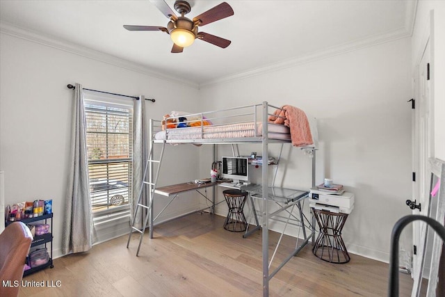 bedroom with ceiling fan, ornamental molding, and hardwood / wood-style floors