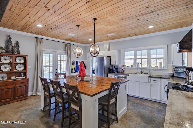 kitchen with wooden ceiling, concrete floors, a sink, stainless steel refrigerator with ice dispenser, and crown molding