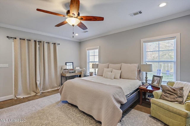 carpeted bedroom featuring visible vents, baseboards, a ceiling fan, ornamental molding, and recessed lighting