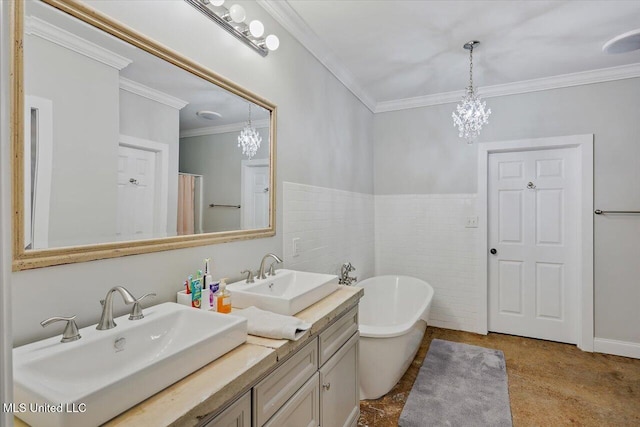 bathroom with double vanity, crown molding, a freestanding bath, and a sink