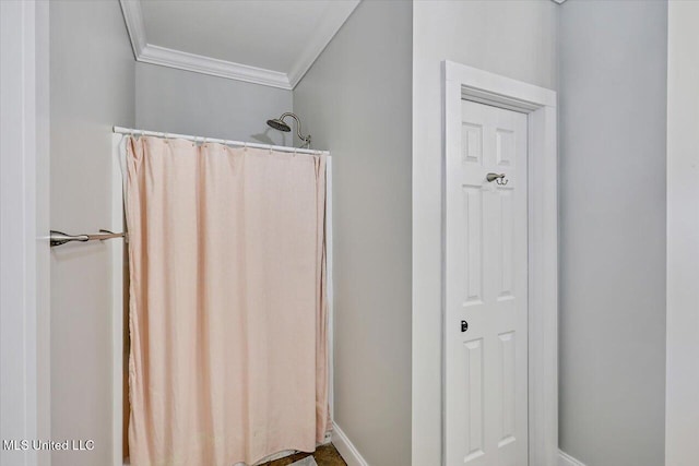 bathroom featuring ornamental molding and a shower with shower curtain