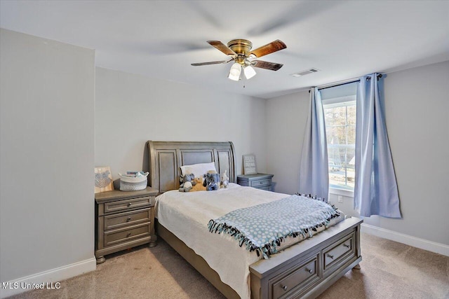 bedroom with light colored carpet, visible vents, ceiling fan, and baseboards