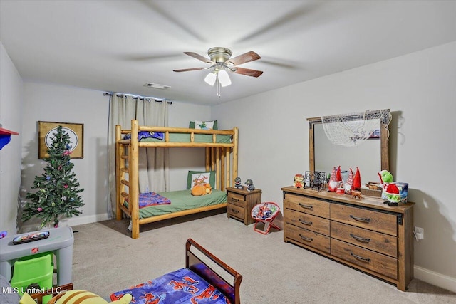 carpeted bedroom with baseboards, visible vents, and a ceiling fan