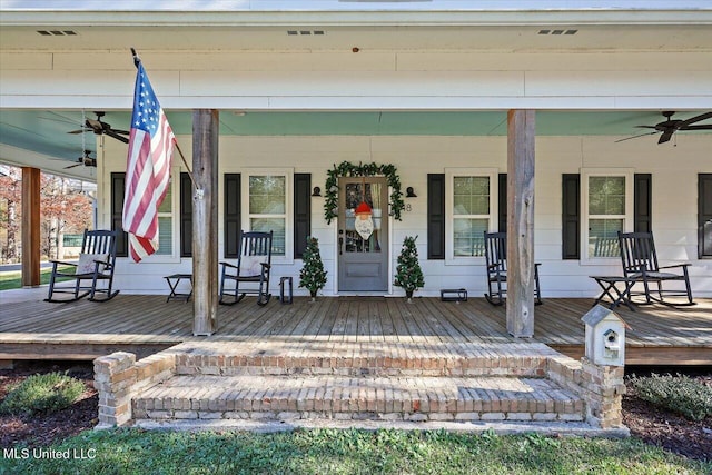 entrance to property with covered porch, ceiling fan, and visible vents