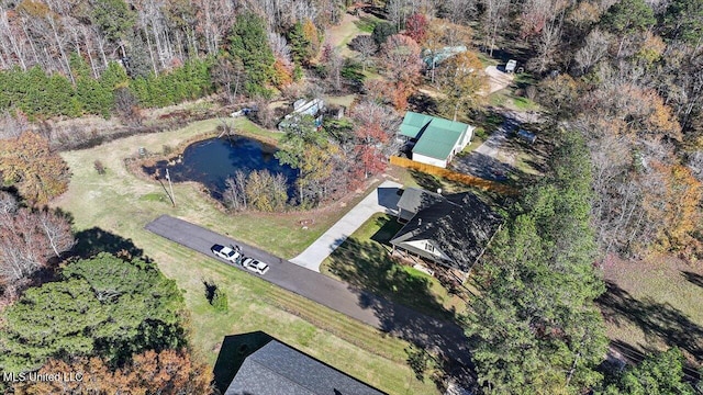 drone / aerial view with a wooded view