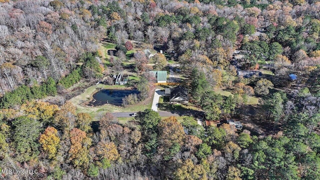 drone / aerial view featuring a wooded view