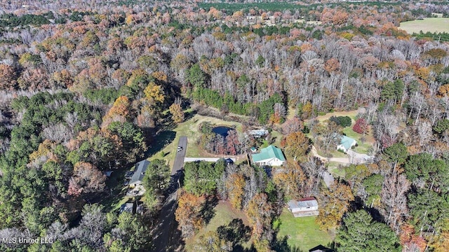 birds eye view of property featuring a view of trees