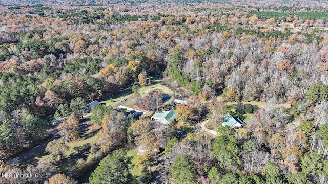 drone / aerial view with a wooded view