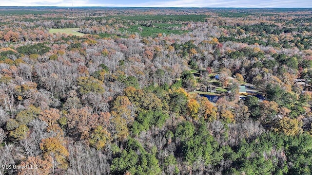 drone / aerial view featuring a forest view