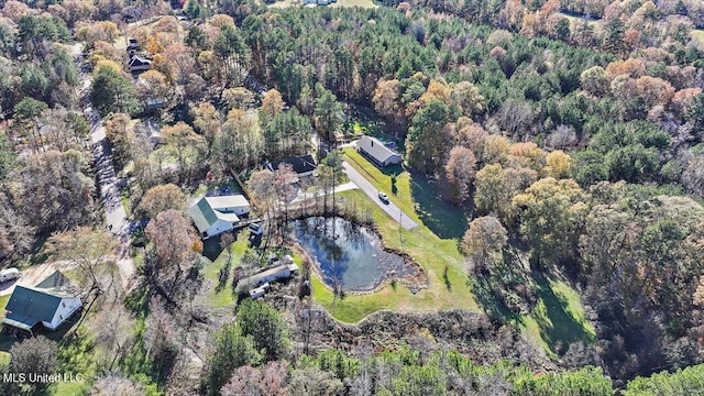 birds eye view of property with a forest view