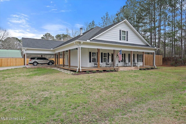 farmhouse inspired home with a porch, a front lawn, and fence