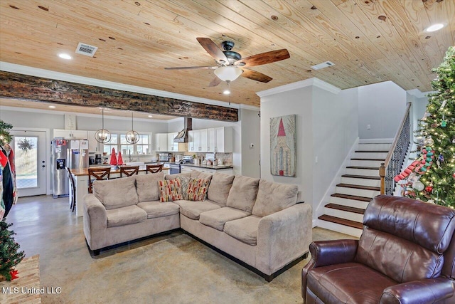 living area featuring finished concrete flooring, visible vents, wooden ceiling, stairway, and crown molding