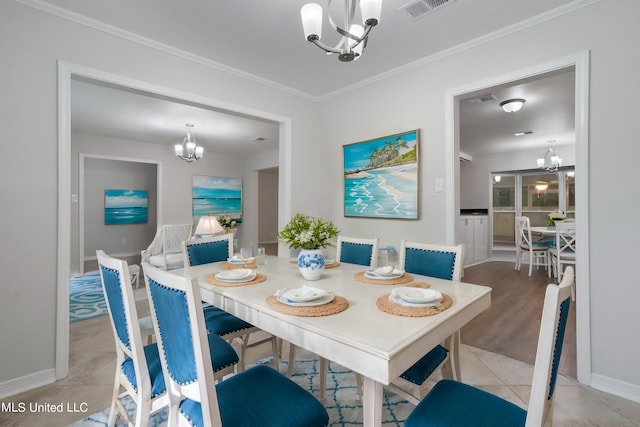 dining space featuring ornamental molding, an inviting chandelier, and light tile patterned floors