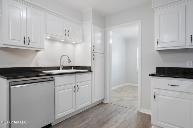 kitchen with light wood-type flooring, sink, stainless steel dishwasher, and white cabinets