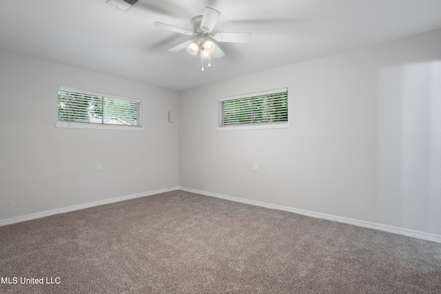 carpeted empty room featuring ceiling fan