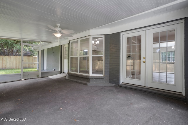 unfurnished sunroom featuring french doors and ceiling fan