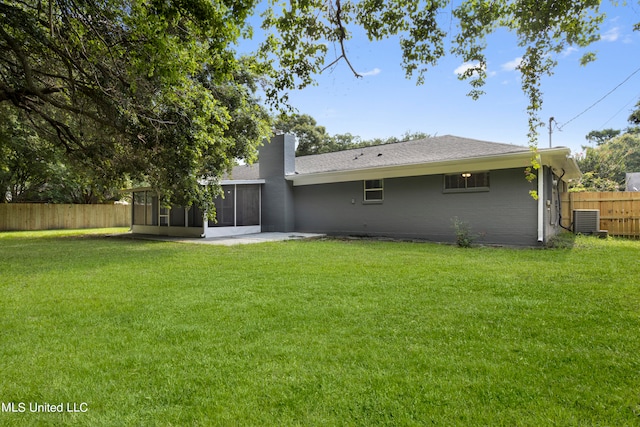 back of house with a patio area, central AC, a lawn, and a sunroom