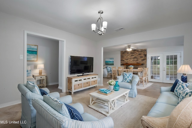 living room with french doors and ceiling fan with notable chandelier